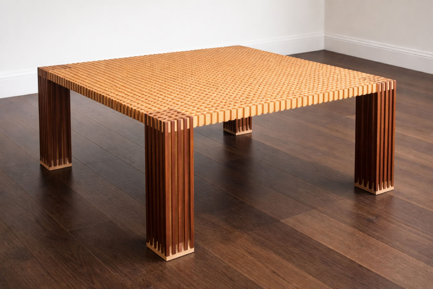 A wooden coffee table with a textured top and four sturdy legs, placed on a dark wood floor in a corner of a room.