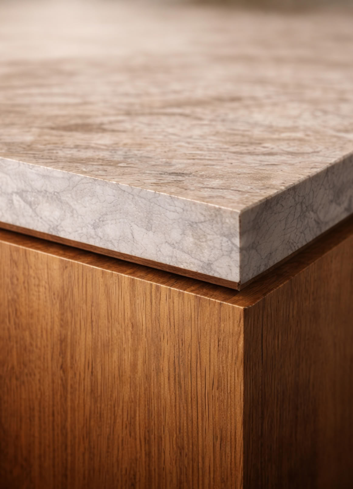 Close-up of a corner of a wooden cabinet with a stone countertop.